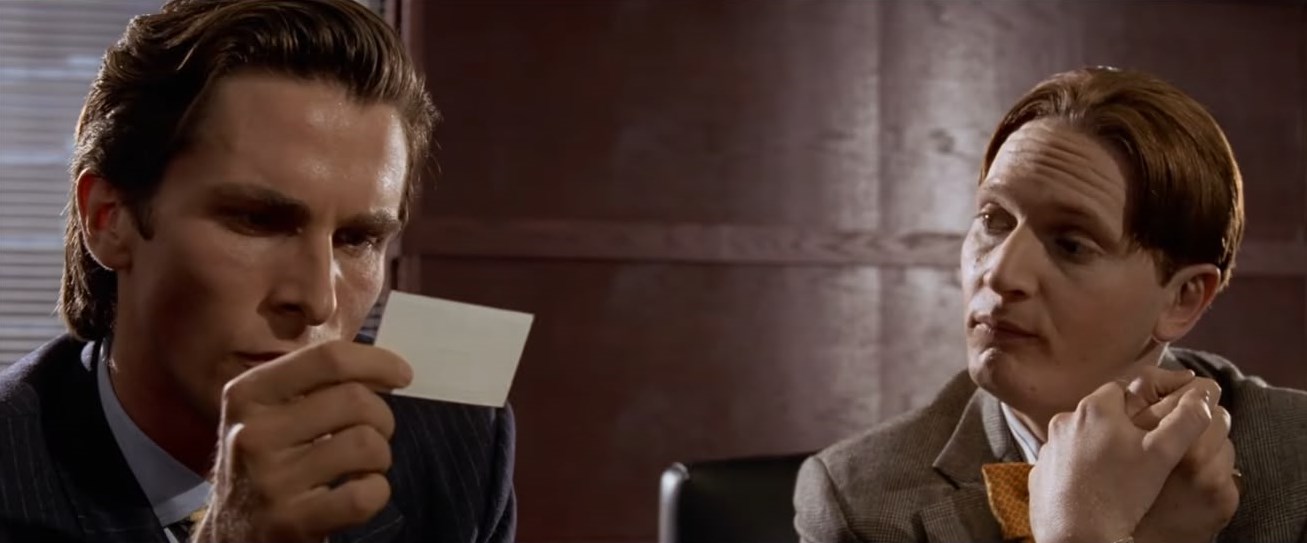 Patrick Bateman inspecting a business card — American Psycho